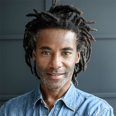 Portrait of a professional man with braids and chambray shirt