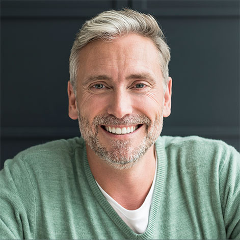 Portrait of an older professional man with gray hair and beard