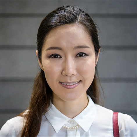 Portrait of a professional woman in a white shirt and pearls