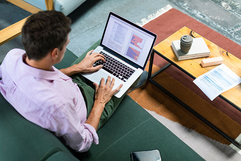 A man works on reports on a laptop